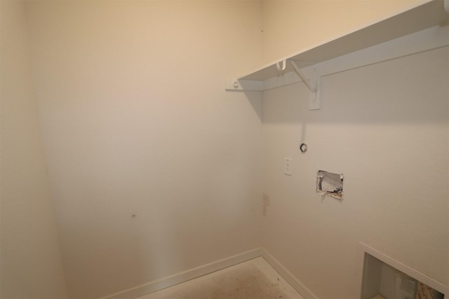 clothes washing area featuring baseboards, washer hookup, and laundry area