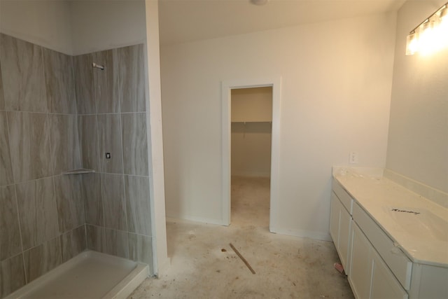 bathroom featuring baseboards, concrete flooring, and a stall shower