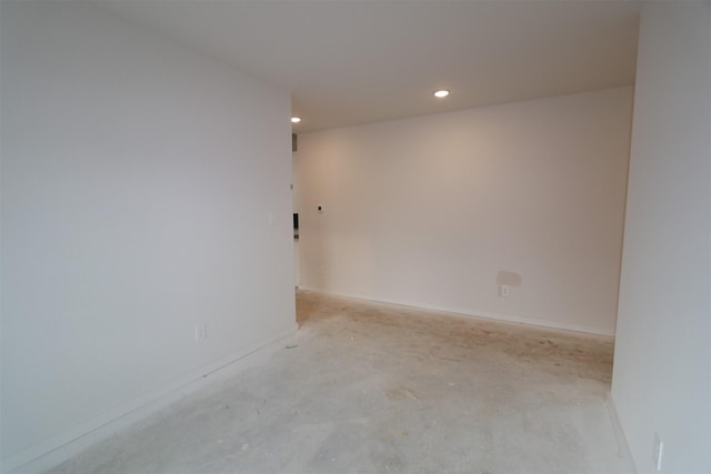 empty room with recessed lighting, baseboards, and concrete flooring