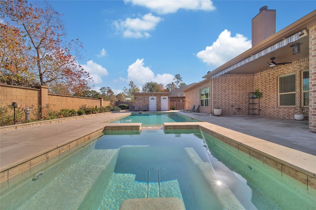 view of swimming pool with ceiling fan, an in ground hot tub, and a patio