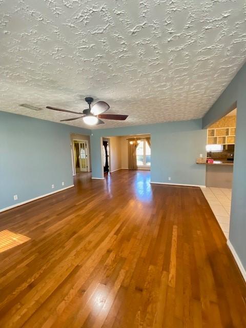 empty room featuring ceiling fan and wood-type flooring