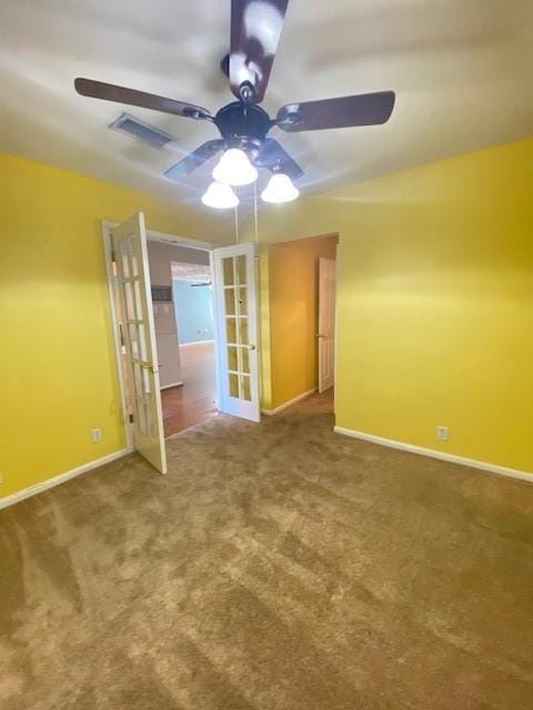 carpeted empty room with french doors and ceiling fan