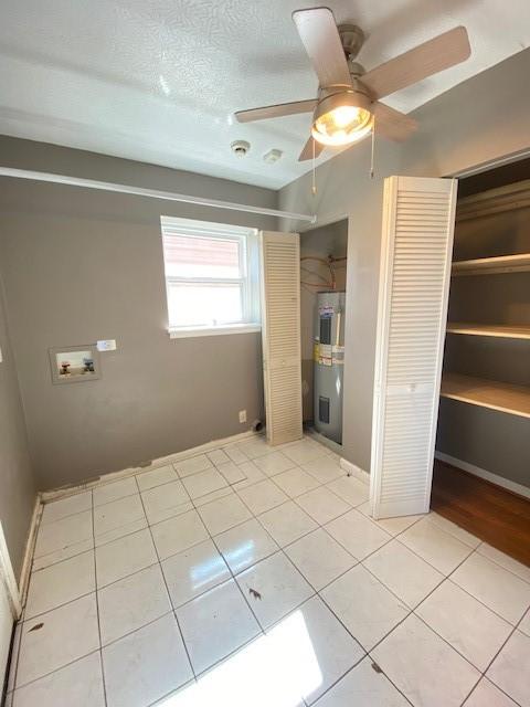 unfurnished bedroom with ceiling fan, a closet, and light tile patterned floors