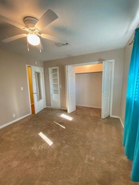 unfurnished bedroom featuring ceiling fan, a closet, and carpet floors