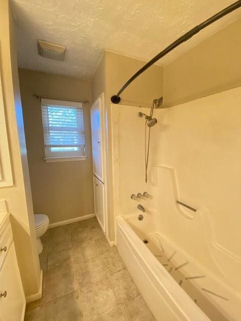 full bathroom featuring vanity, bathtub / shower combination, a textured ceiling, and toilet