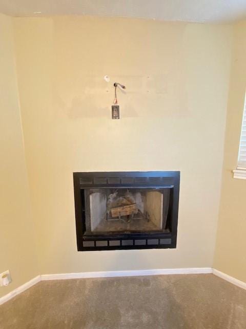 interior details featuring carpet flooring and a fireplace