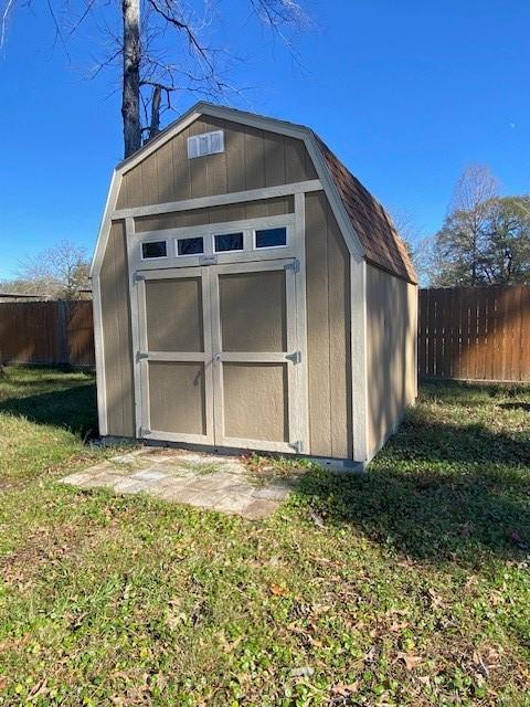 view of outbuilding with a lawn