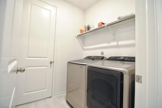 clothes washing area with separate washer and dryer