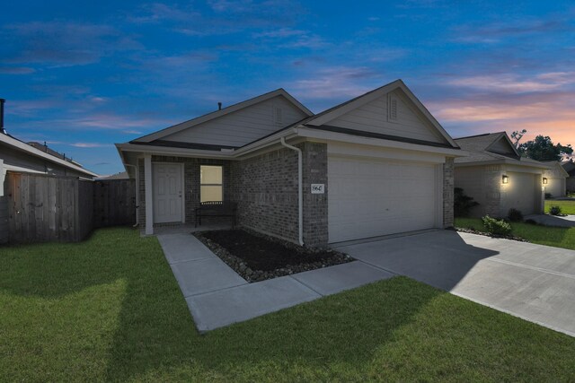 ranch-style home with a yard and a garage