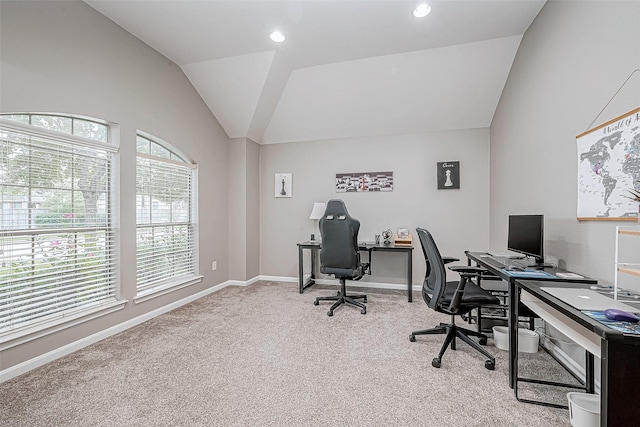 carpeted office featuring plenty of natural light and lofted ceiling