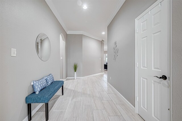 hallway with crown molding and light hardwood / wood-style floors