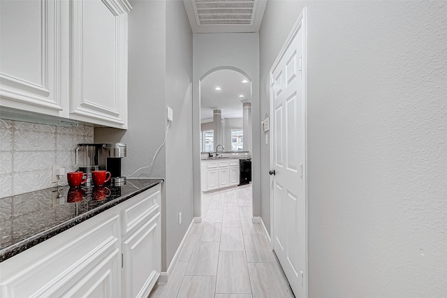 hallway with sink and beverage cooler