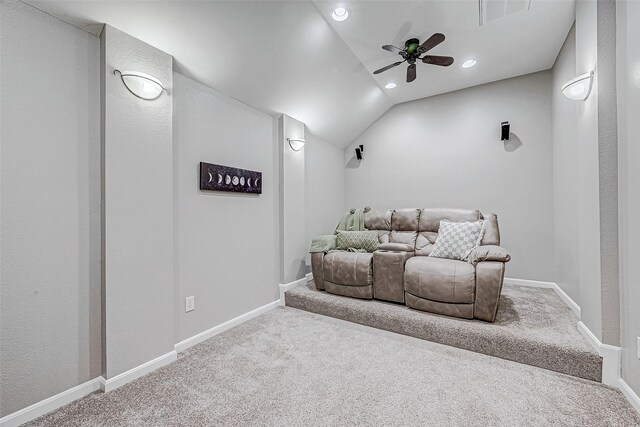 carpeted home theater room featuring ceiling fan and lofted ceiling