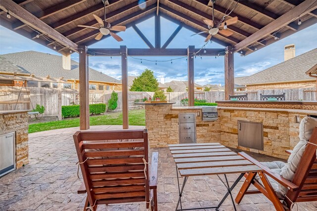 view of patio / terrace featuring a gazebo, an outdoor kitchen, and ceiling fan