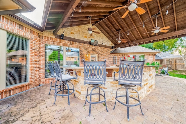 view of patio with a bar and ceiling fan