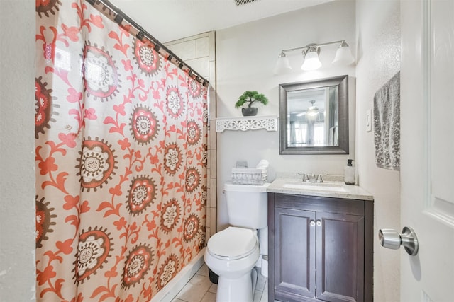 bathroom featuring tile patterned flooring, vanity, curtained shower, and toilet