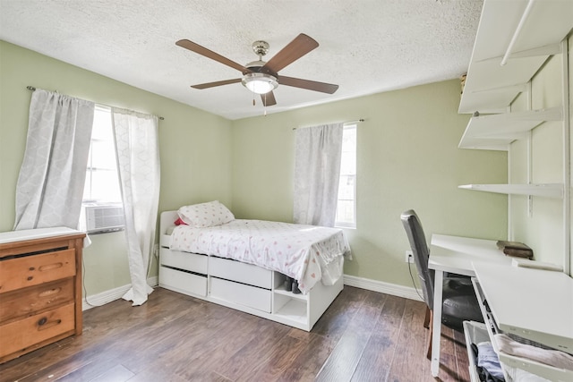 bedroom featuring multiple windows, ceiling fan, cooling unit, and dark hardwood / wood-style floors