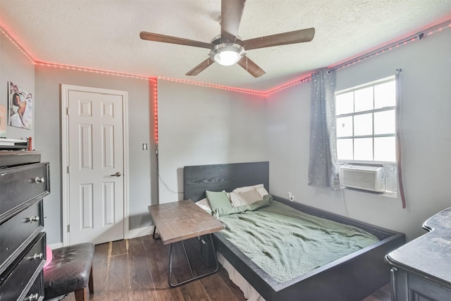 bedroom with ceiling fan, dark hardwood / wood-style floors, a textured ceiling, and cooling unit