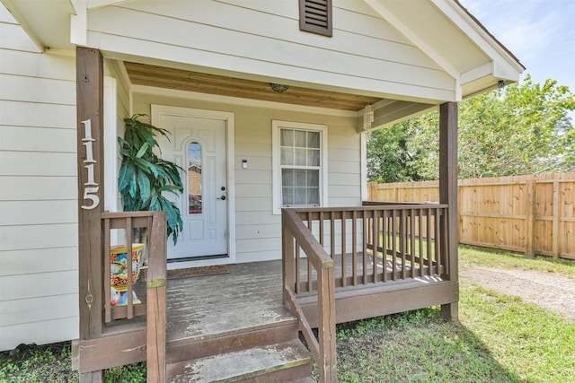 view of exterior entry with a porch