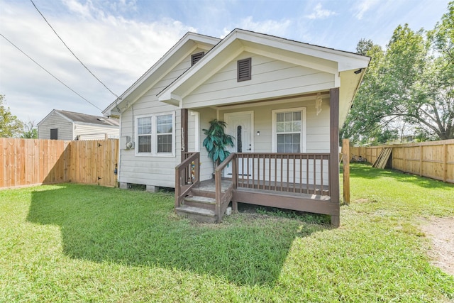 bungalow with a front lawn and a porch