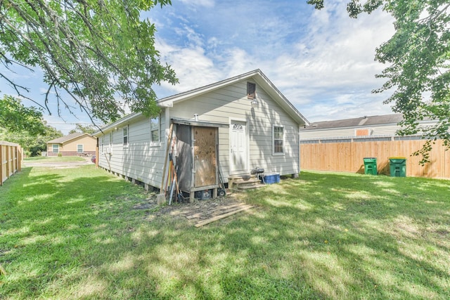 rear view of property with a yard