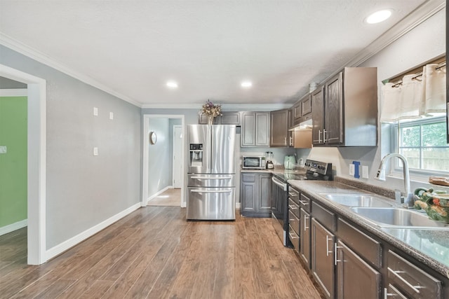 kitchen with dark hardwood / wood-style flooring, dark brown cabinets, stainless steel appliances, crown molding, and sink