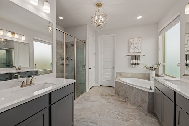 bathroom featuring vanity, shower with separate bathtub, and an inviting chandelier