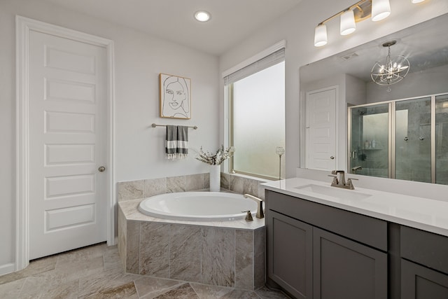 bathroom with plus walk in shower, vanity, and a notable chandelier