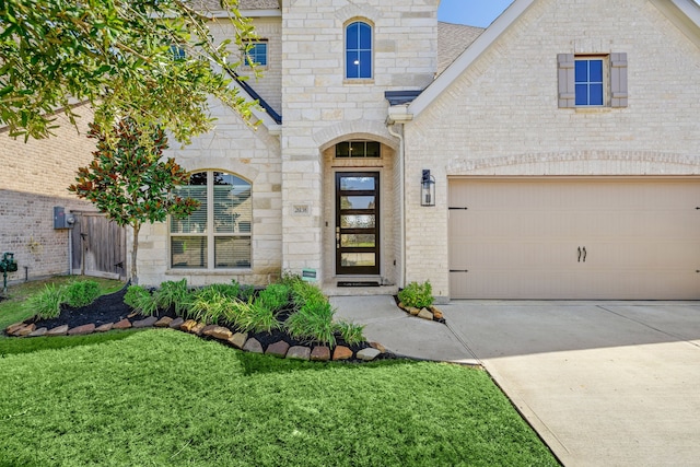 doorway to property with a yard and a garage