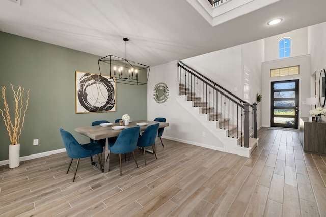 dining space featuring light hardwood / wood-style floors and an inviting chandelier