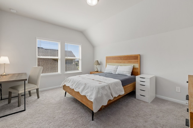 bedroom featuring light colored carpet and lofted ceiling