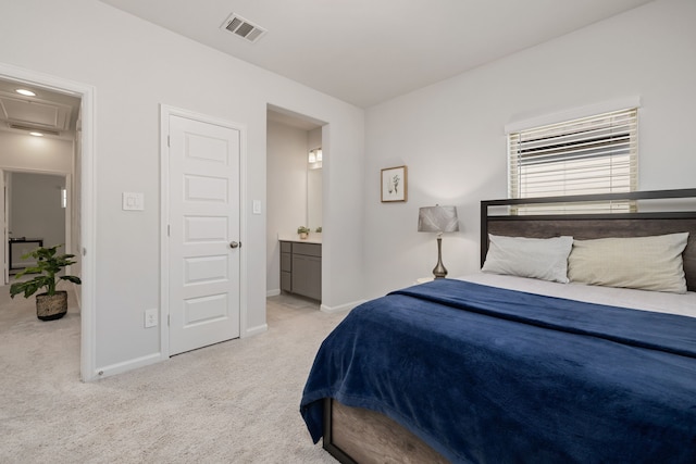 bedroom with light carpet and ensuite bathroom