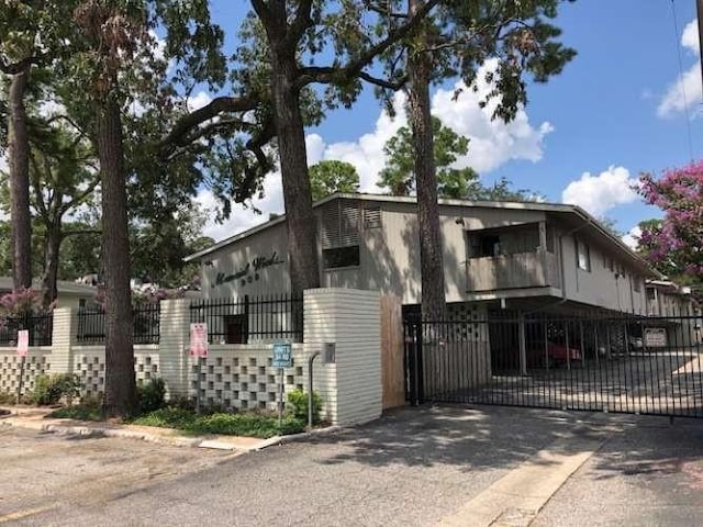 909 Silber Rd Unit 4A, Houston, TX 77024 - view of front of property featuring driveway, fence, and a gate