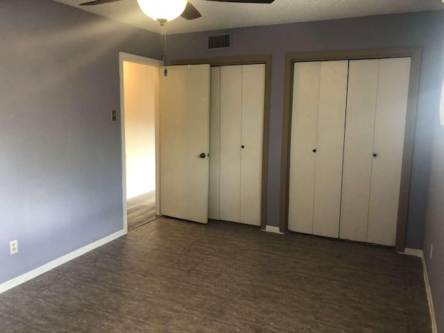 909 Silber Rd Unit 4A, Houston, TX 77024 - unfurnished bedroom with ceiling fan, multiple closets, baseboards, wood finished floors, and visible vents