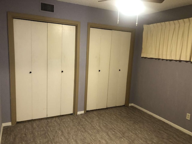 909 Silber Rd Unit 4A, Houston, TX 77024 - unfurnished bedroom featuring multiple closets, baseboards, ceiling fan, and visible vents