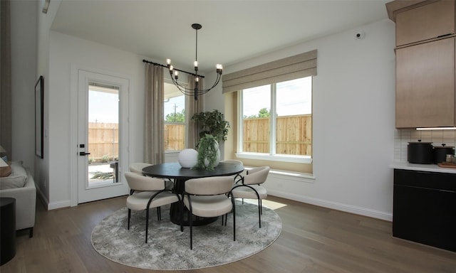 dining area with an inviting chandelier and light hardwood / wood-style flooring