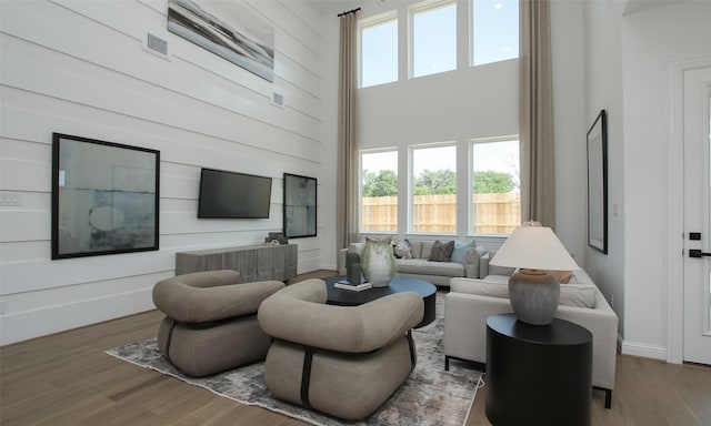 living room featuring a high ceiling and hardwood / wood-style flooring