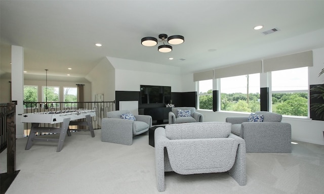 living room with light carpet and a healthy amount of sunlight