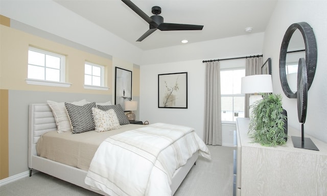 bedroom featuring light colored carpet and ceiling fan