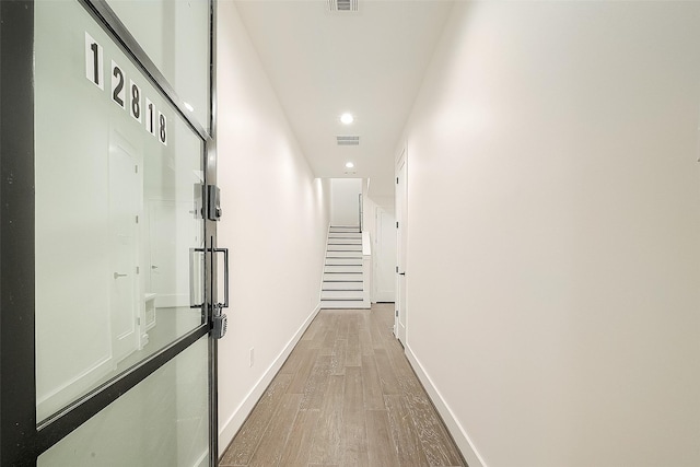 hallway with wood-type flooring