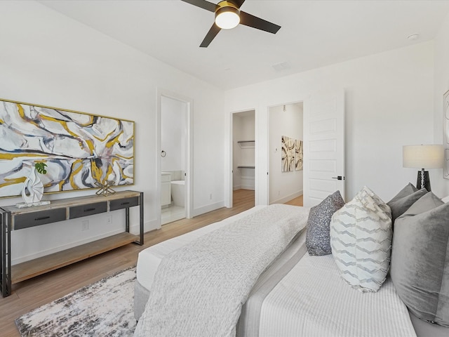 bedroom featuring ensuite bath, ceiling fan, a spacious closet, hardwood / wood-style floors, and a closet