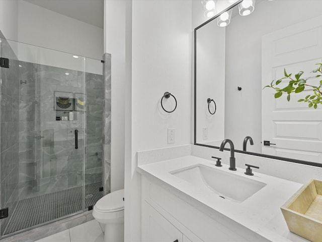 bathroom featuring tile patterned flooring, vanity, toilet, and a shower with door