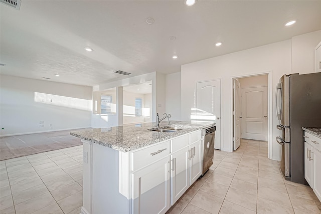 kitchen with white cabinets, sink, a kitchen island with sink, and stainless steel appliances