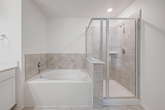 bathroom featuring separate shower and tub and vanity