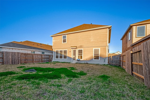 rear view of property featuring a yard