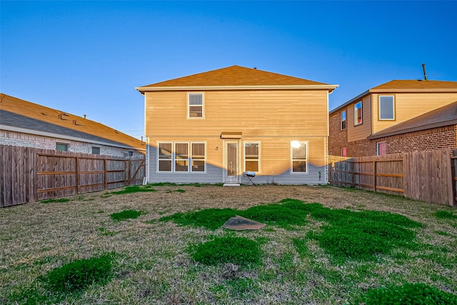 back of house featuring a yard