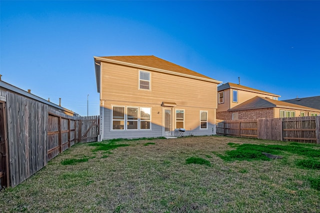 rear view of house featuring a lawn