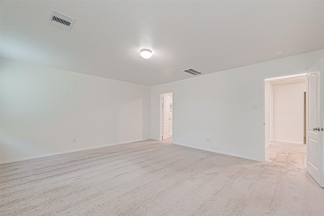 carpeted spare room with a textured ceiling