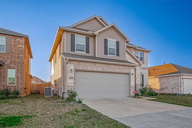 view of front of property with a garage and central AC