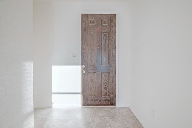 hallway featuring light tile patterned flooring